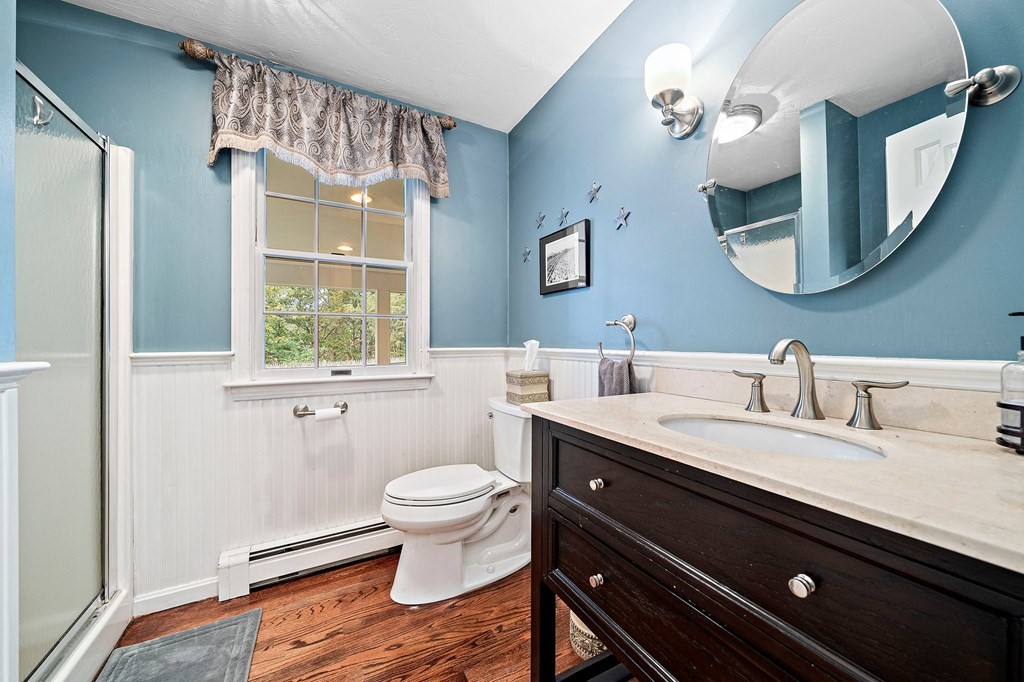 20 Spring Valley Road Hull, MA 02045 - Photo 13 of 30 a bathroom with a granite countertop toilet a sink and a mirror