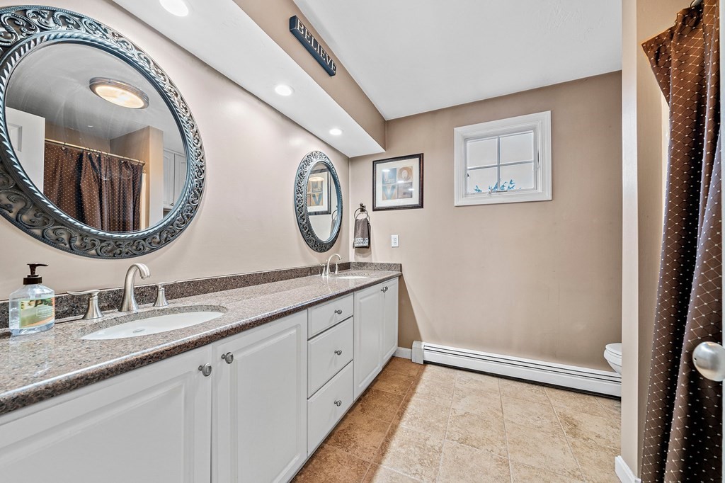20 Spring Valley Road Hull, MA 02045 - Photo 17 of 30 a bathroom with a double vanity sink and a mirror