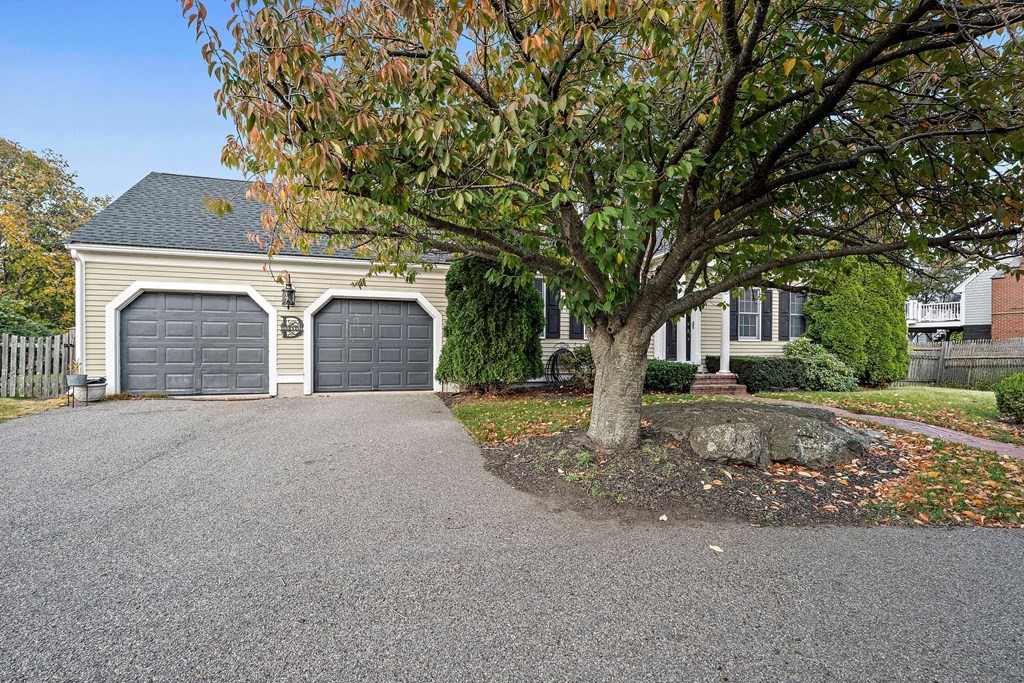 20 Spring Valley Road Hull, MA 02045 - Photo 3 of 30 a front view of a house with a yard and garage