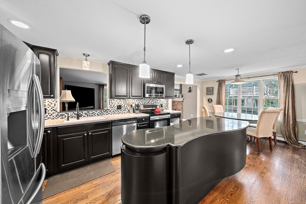 20 Spring Valley Road Hull, MA 02045 - Photo 4 of 30 a kitchen with stainless steel appliances granite countertop a sink stove and refrigerator