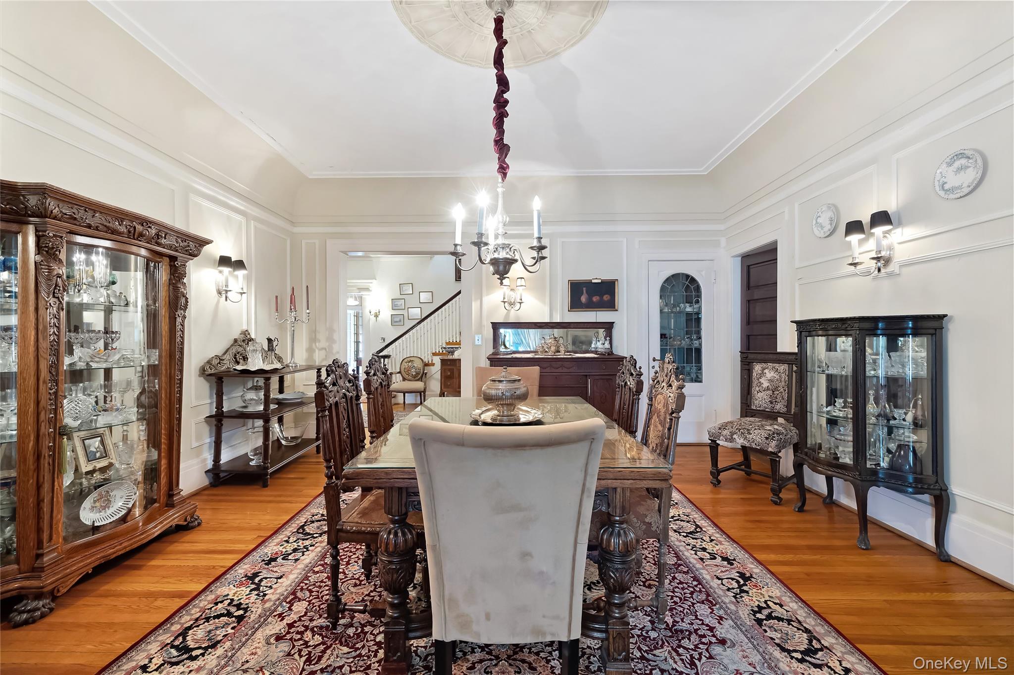 1-27 Beverly Road Queens, NY 11363 - Photo 37 of 46 a dining room with furniture a chandelier and wooden floor