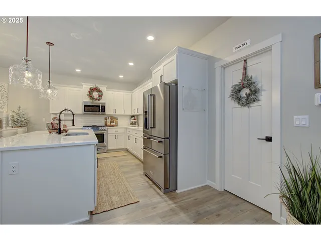 a open kitchen with kitchen island a refrigerator stove and a sink