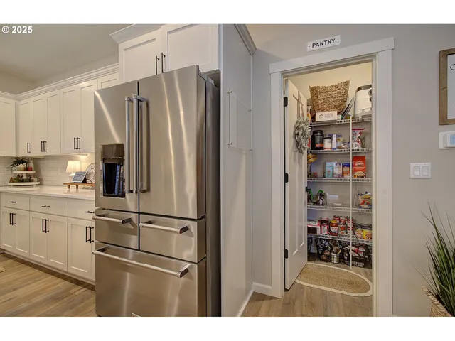 a kitchen with stainless steel appliances a refrigerator and cabinets