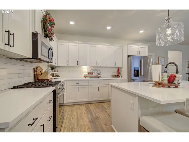 a kitchen with a sink stainless steel appliances and cabinets