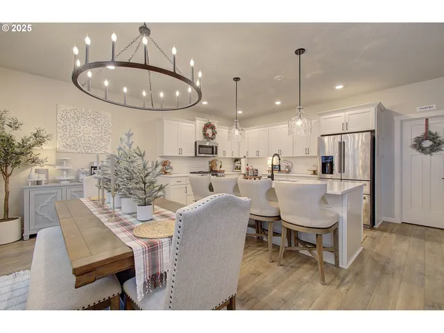 a dining room with furniture and kitchen view