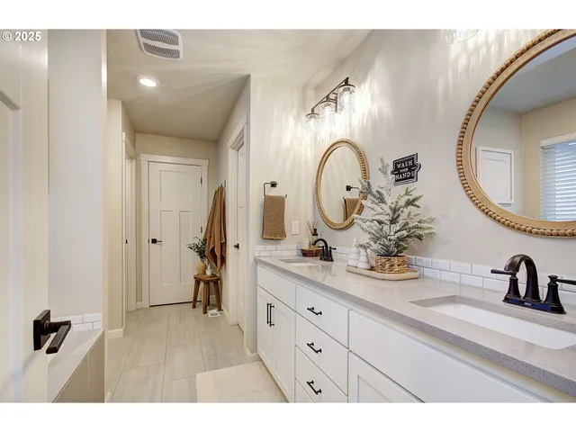 a bathroom with a double vanity sink and a mirror