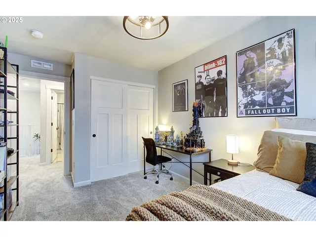 a living room with furniture and a painting on the wall