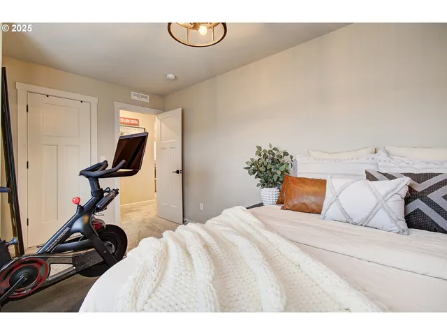 a bedroom with a bed and gym equipment