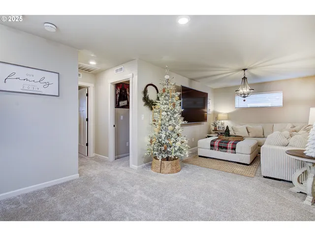 a living room with furniture and a chandelier