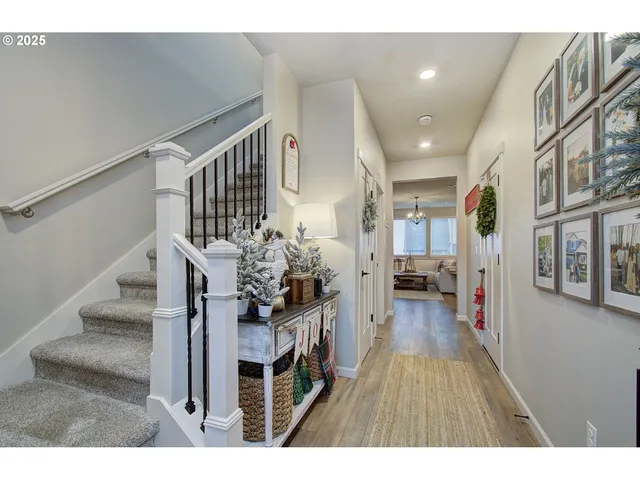 a view of entryway and hall with wooden floor