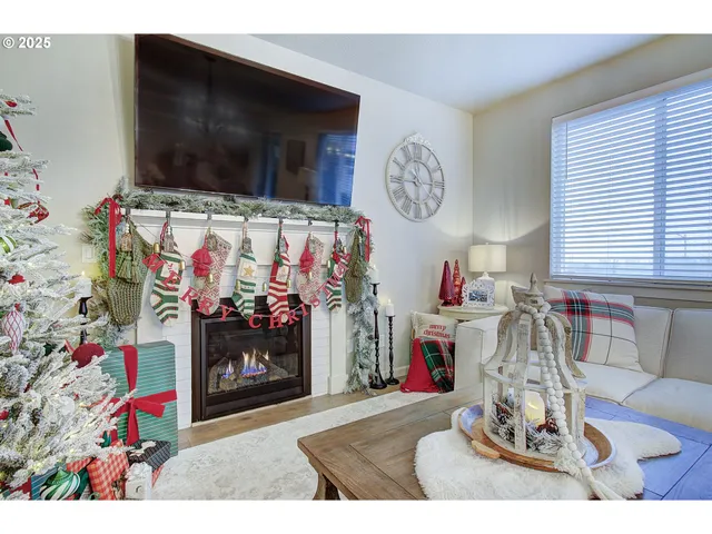a living room with fireplace furniture and a flat screen tv