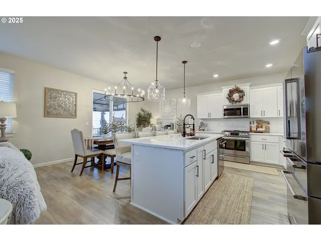 a open kitchen with cabinets a sink and appliances