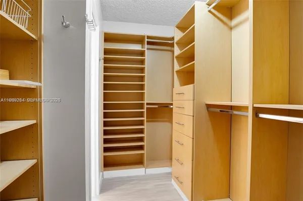 a view of walk in closet with empty shelves