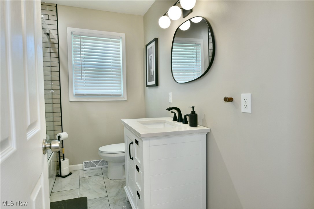 4400 Ridge Road Cortland, OH 44410 - Photo 9 of 50 Bathroom featuring vanity, a shower, and light marble finish flooring