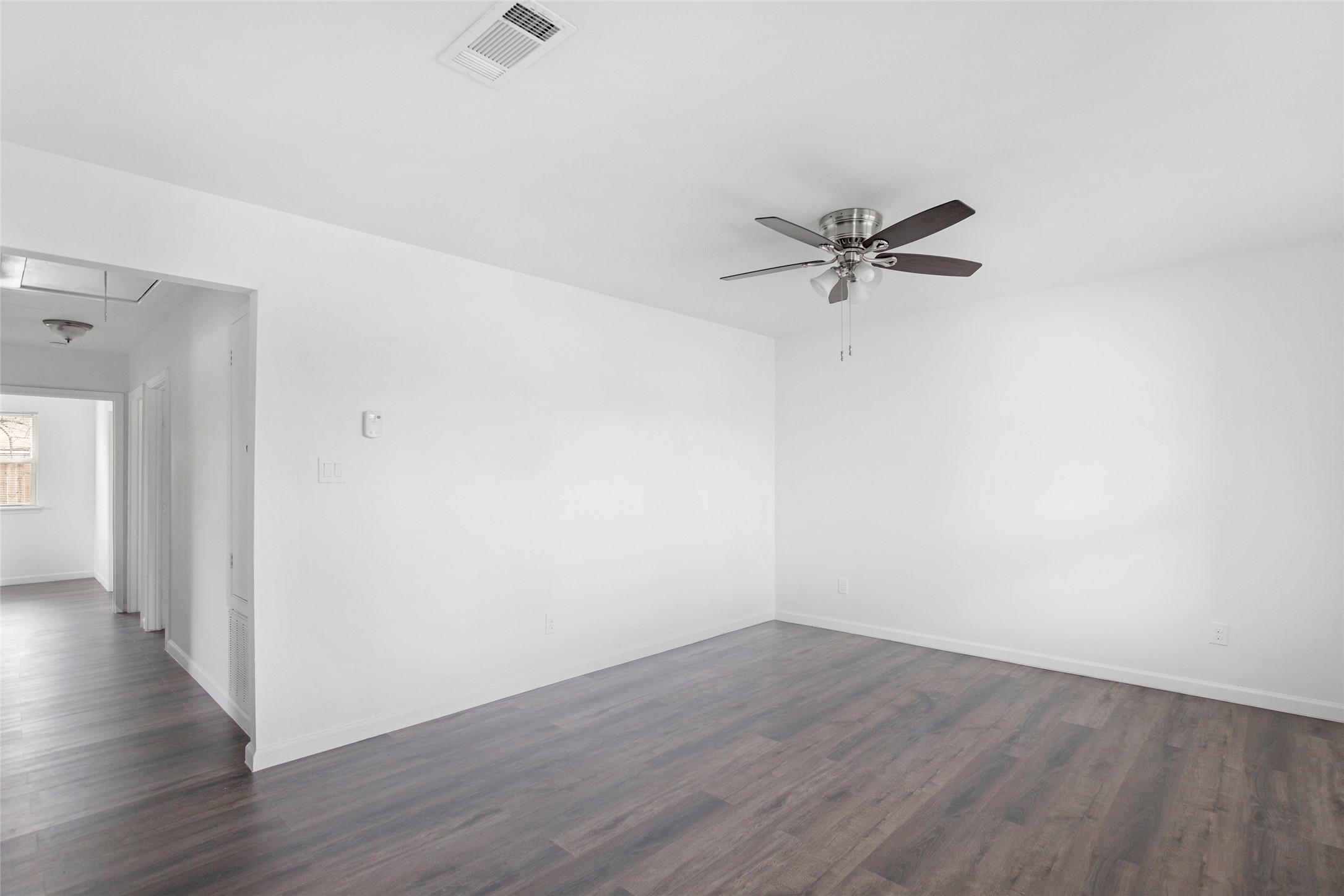 6721 Madrid Street Houston, TX 77021 - Photo 11 of 19 a view of a room with wooden floor and a ceiling fan