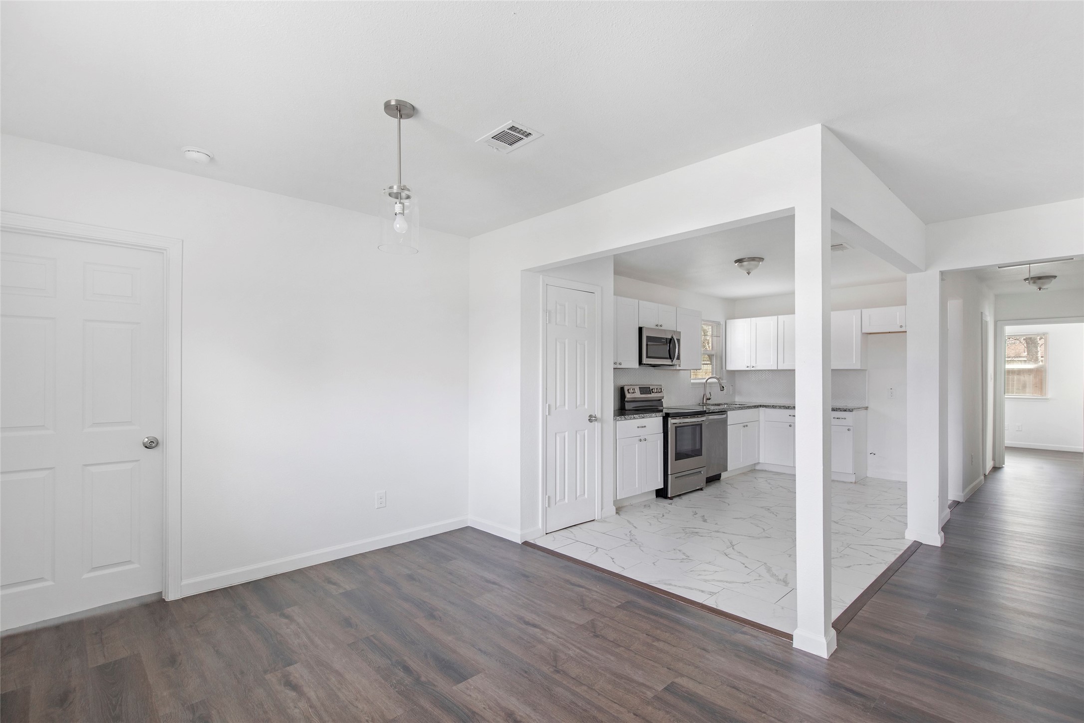 6721 Madrid Street Houston, TX 77021 - Photo 3 of 19 a view of a kitchen with a sink and wooden floor