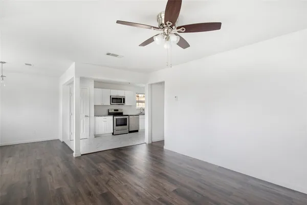 a kitchen with white cabinets stainless steel appliances and sink