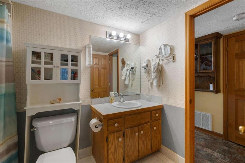 125 Circle Drive Hampton, GA 30228 - Photo 11 of 36 a bathroom with a toilet sink and mirror