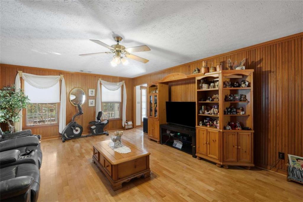 125 Circle Drive Hampton, GA 30228 - Photo 14 of 36 a living room with furniture a flat screen tv and a large window