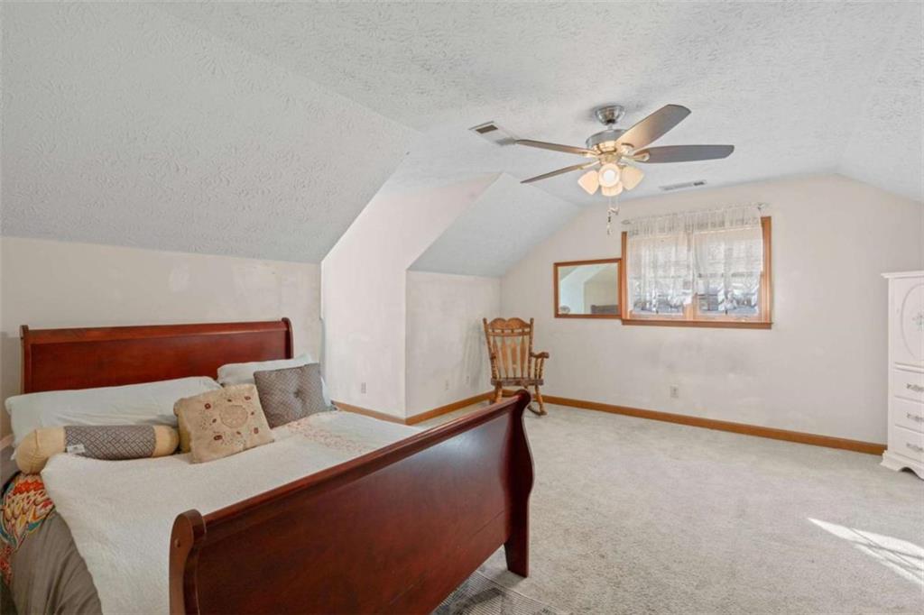 125 Circle Drive Hampton, GA 30228 - Photo 24 of 36 a bedroom with a bed and a chandelier