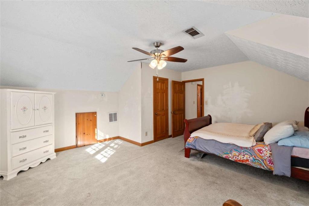 125 Circle Drive Hampton, GA 30228 - Photo 25 of 36 a bedroom with a bed and a ceiling fan