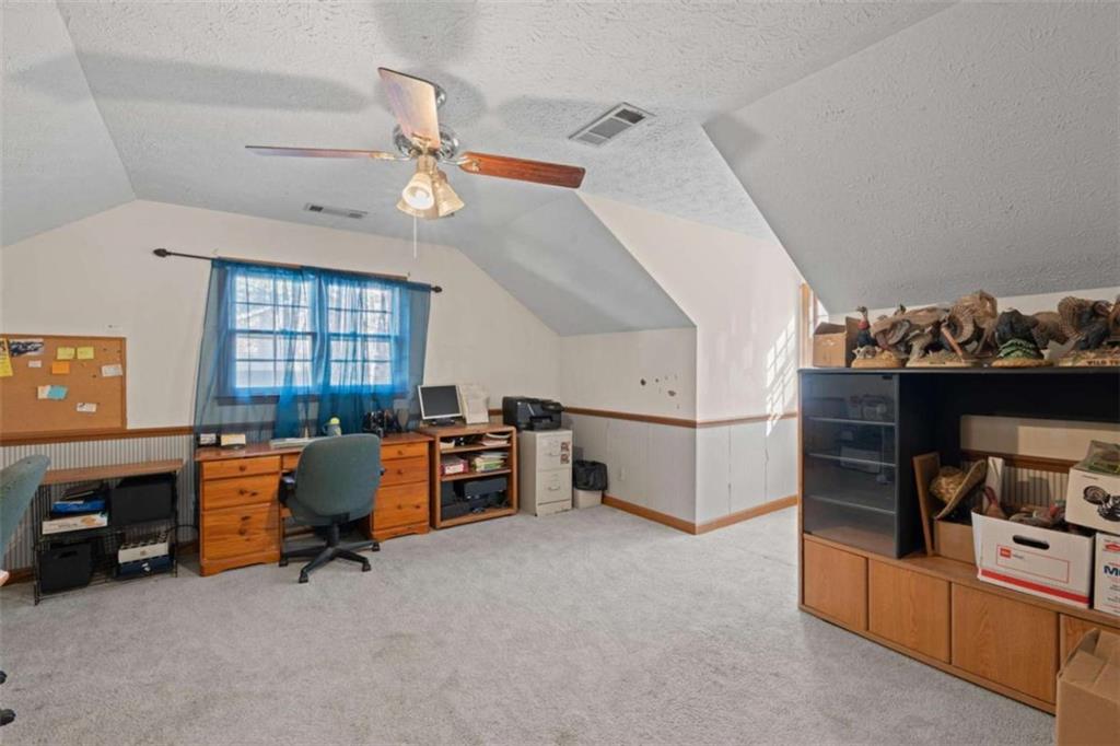 125 Circle Drive Hampton, GA 30228 - Photo 26 of 36 a view of a workspace with furniture and a ceiling fan