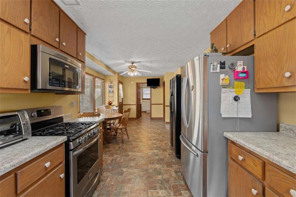 125 Circle Drive Hampton, GA 30228 - Photo 4 of 36 a kitchen with stainless steel appliances granite countertop a refrigerator a stove top oven a sink and dishwasher