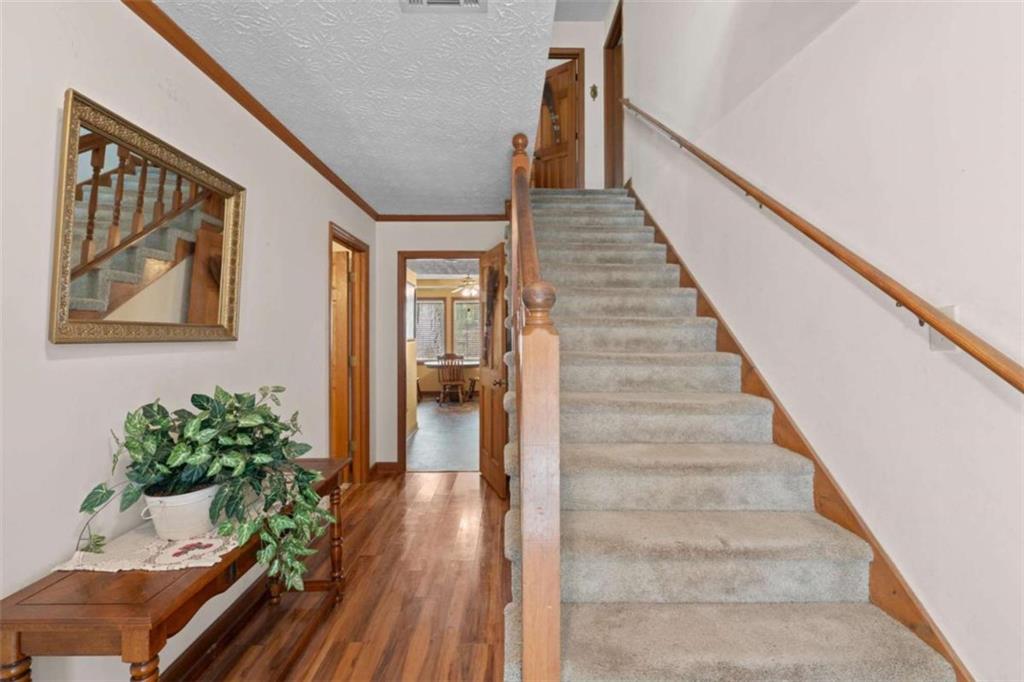 125 Circle Drive Hampton, GA 30228 - Photo 7 of 36 a view of entryway and hall with wooden floor