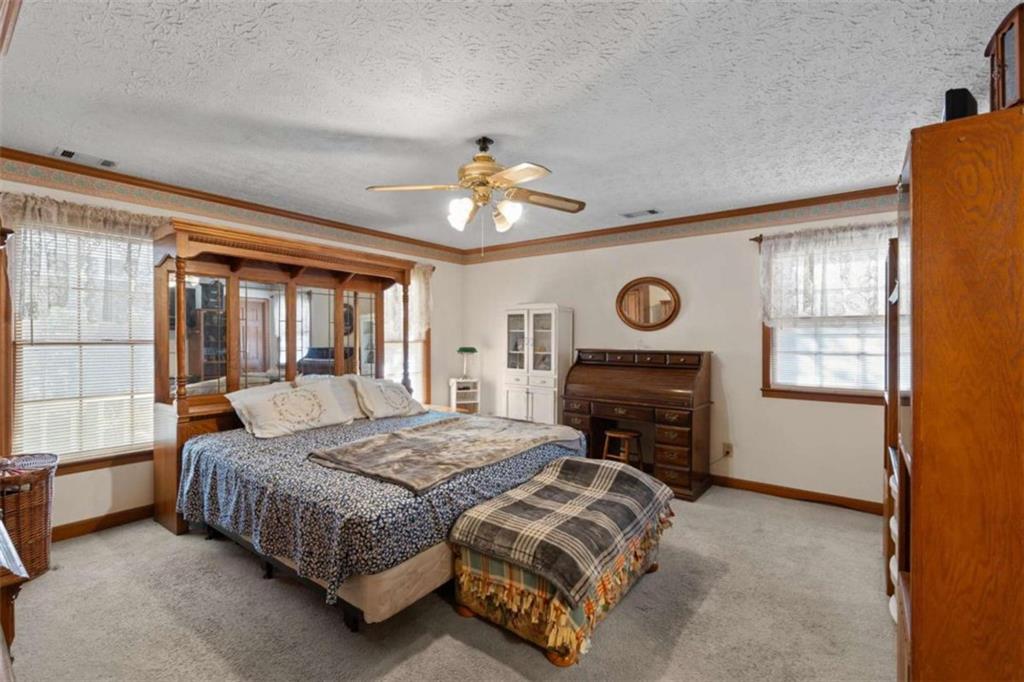 125 Circle Drive Hampton, GA 30228 - Photo 9 of 36 a bedroom with a bed dresser and a window