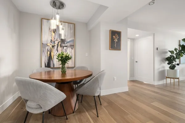 a view of a dining room with furniture and wooden floor