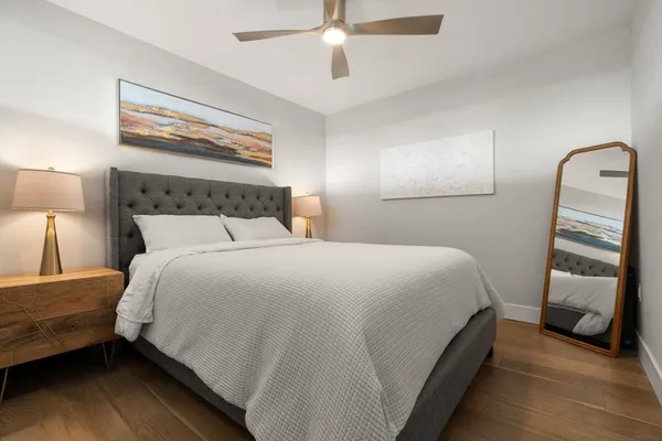 a bedroom with a bed and a lamp