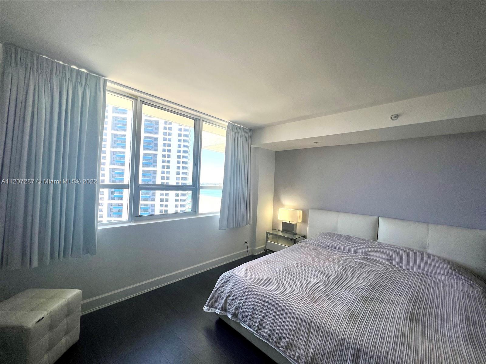 1500 Bay Road, Unit 1414S Miami Beach, FL 33139 - Photo 12 of 23 a bedroom with a bed and a window