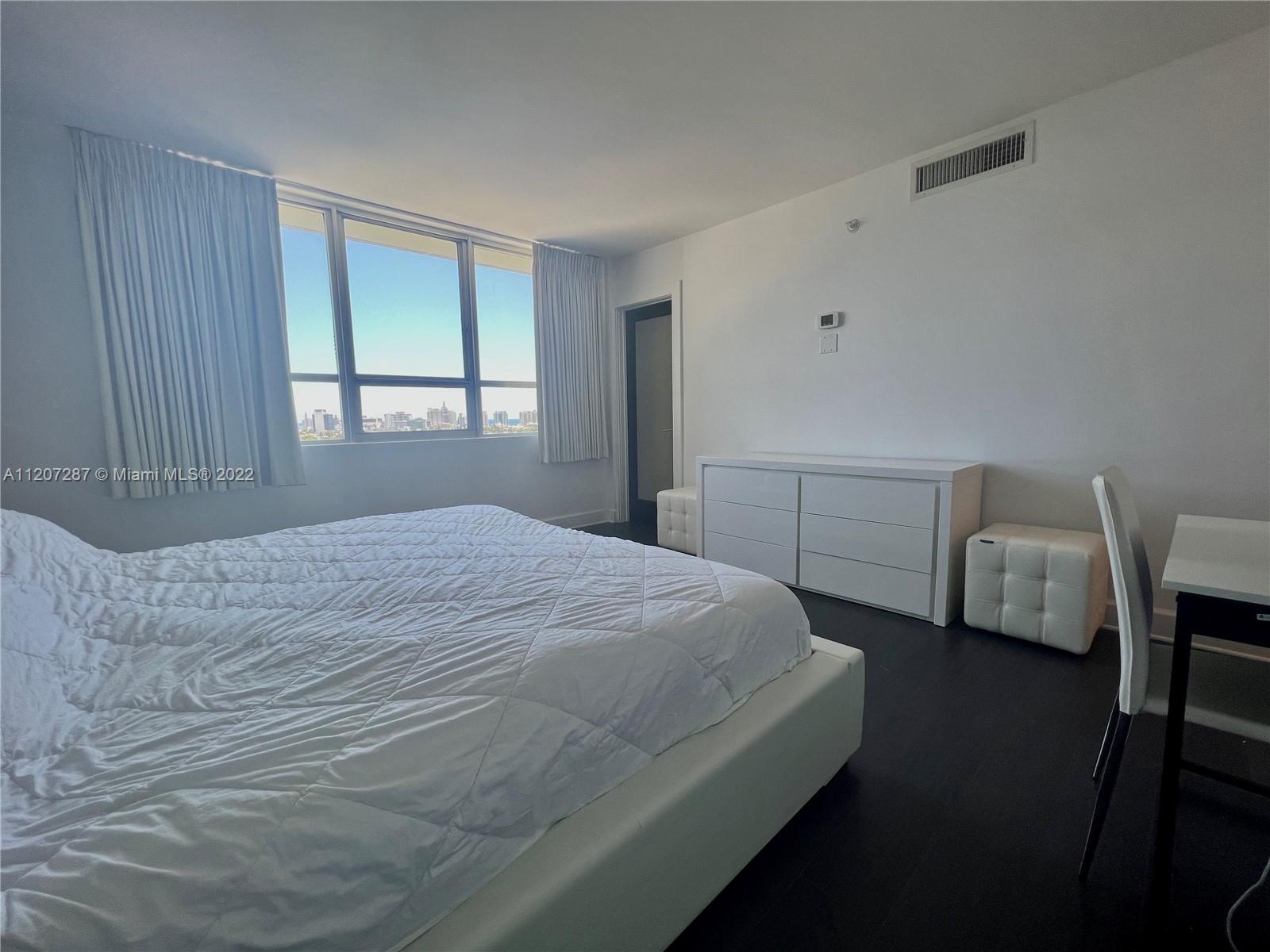 1500 Bay Road, Unit 1414S Miami Beach, FL 33139 - Photo 14 of 23 a bedroom with a bed and window