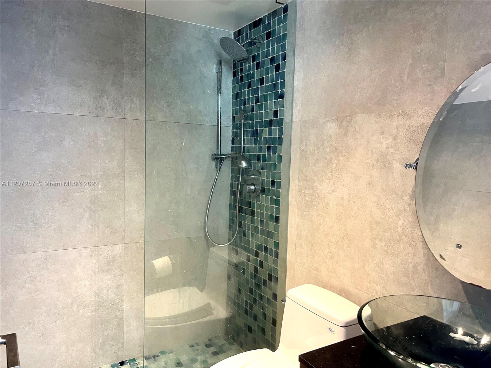 1500 Bay Road, Unit 1414S Miami Beach, FL 33139 - Photo 15 of 23 a bathroom with a sink and a mirror