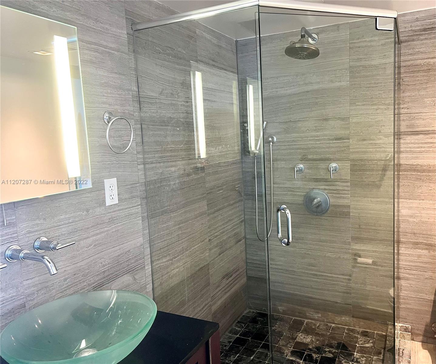 1500 Bay Road, Unit 1414S Miami Beach, FL 33139 - Photo 9 of 23 a bathroom with a sink and shower