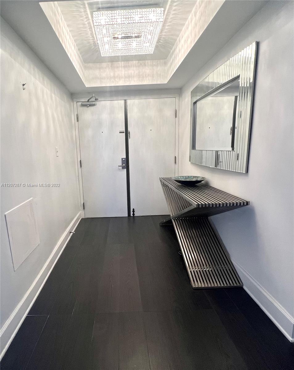 1500 Bay Road, Unit 1414S Miami Beach, FL 33139 - Photo 10 of 23 a view of an empty room with wooden floor and a window