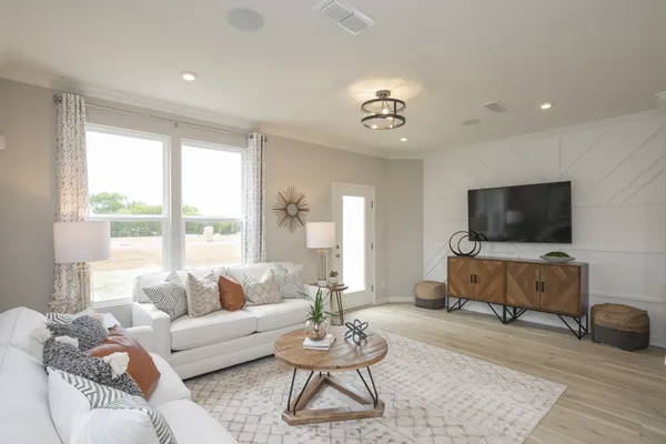 a living room with furniture and a large window