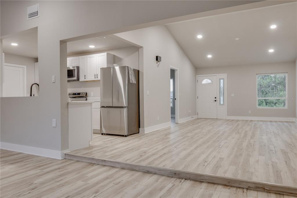 773 Bryant Road Palm Bay, FL 32908 - Photo 3 of 11 a view of a kitchen with a refrigerator and a window