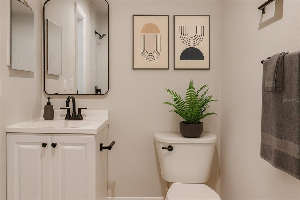 773 Bryant Road Palm Bay, FL 32908 - Photo 7 of 11 a bathroom with a toilet a sink and mirror