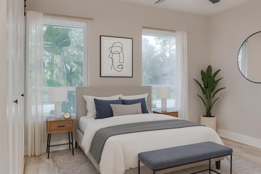 773 Bryant Road Palm Bay, FL 32908 - Photo 8 of 11 a bedroom with a large bed and a potted plant