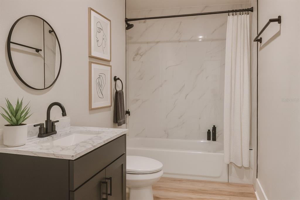773 Bryant Road Palm Bay, FL 32908 - Photo 9 of 11 a bathroom with a granite countertop sink and a mirror