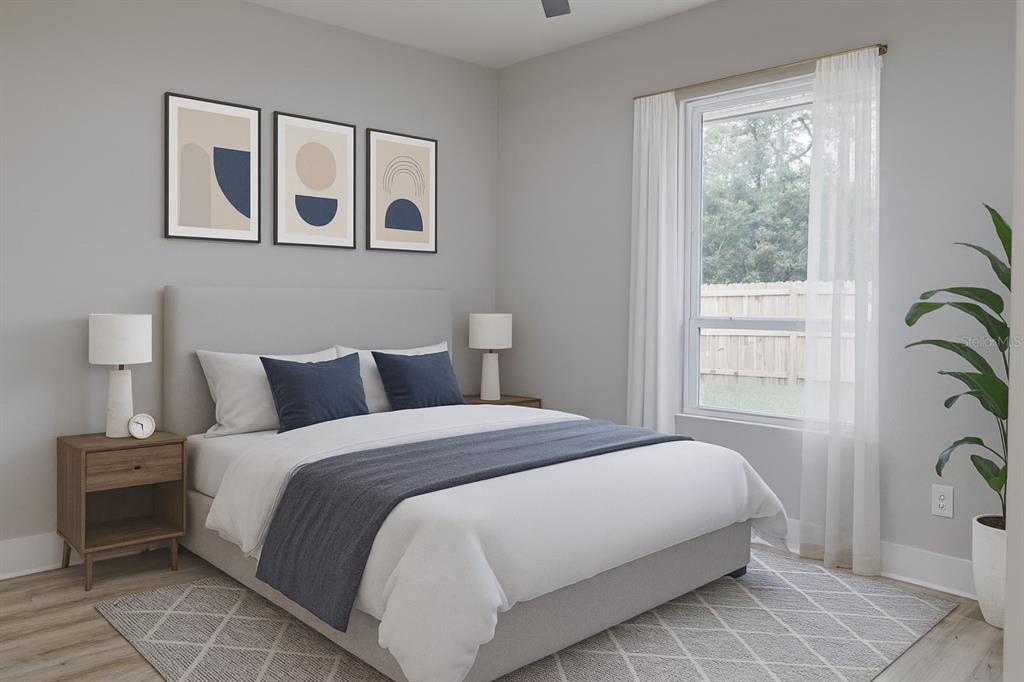 773 Bryant Road Palm Bay, FL 32908 - Photo 10 of 11 a bedroom with a large bed and a potted plant