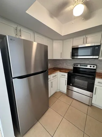 a kitchen with stainless steel appliances a refrigerator sink and microwave