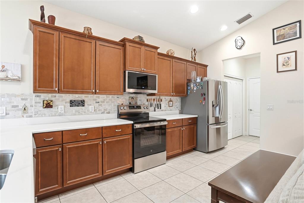 2906 West Douglas Street Tampa, FL 33607 - Photo 12 of 36 a kitchen with stainless steel appliances granite countertop a refrigerator stove and sink