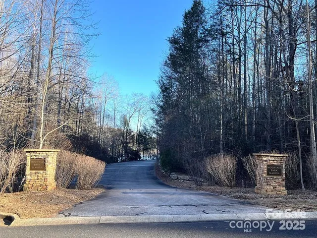 a view of a street with a bench and trees