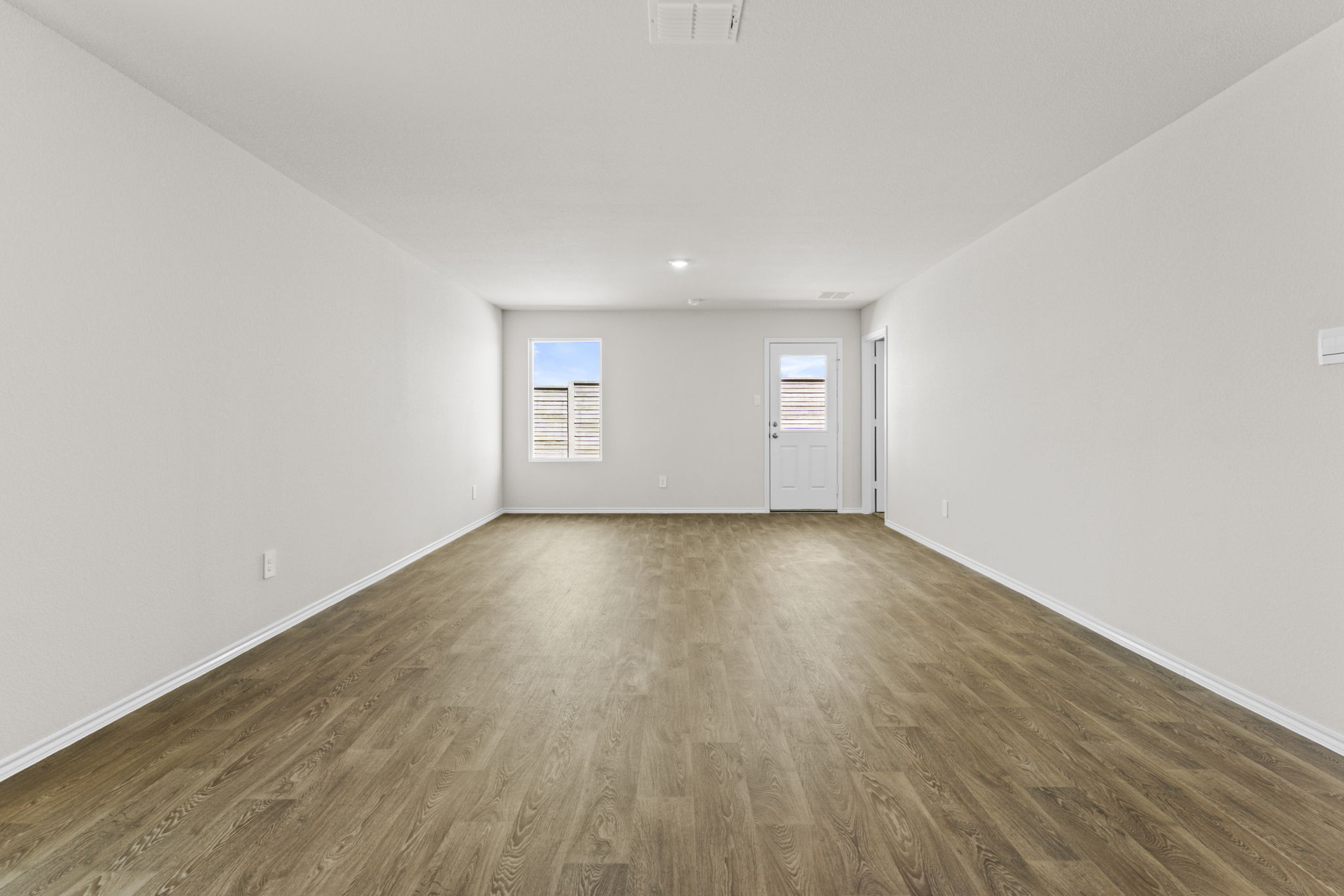 401 Wild Goose Drive Luling, TX 78648 - Photo 19 of 26 an empty room with wooden floor and windows