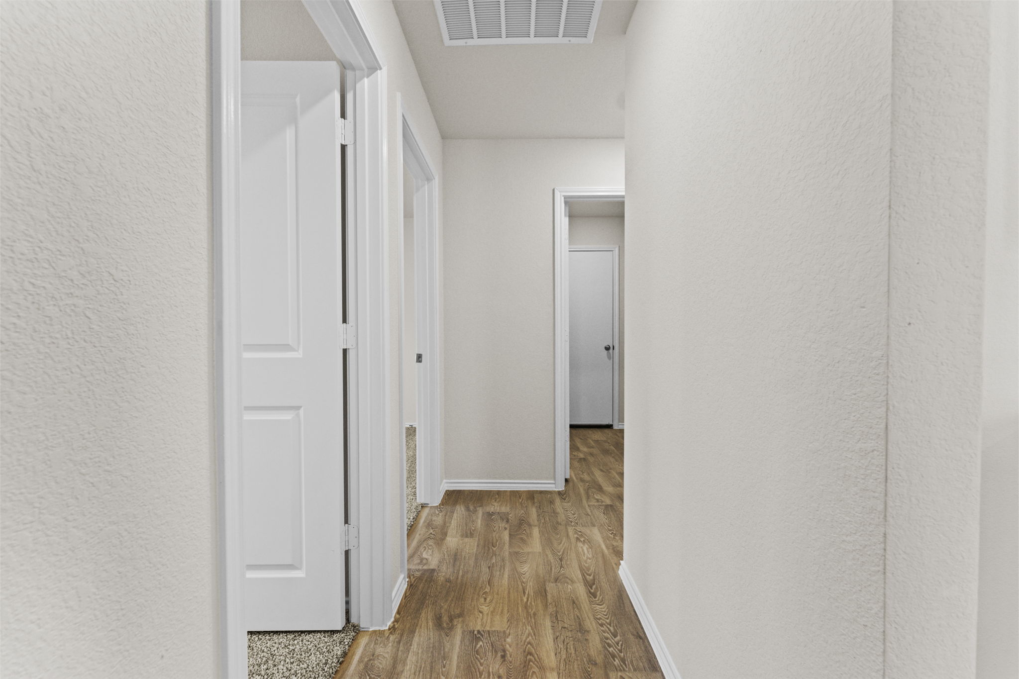 401 Wild Goose Drive Luling, TX 78648 - Photo 9 of 26 a view of a hallway with wooden floor