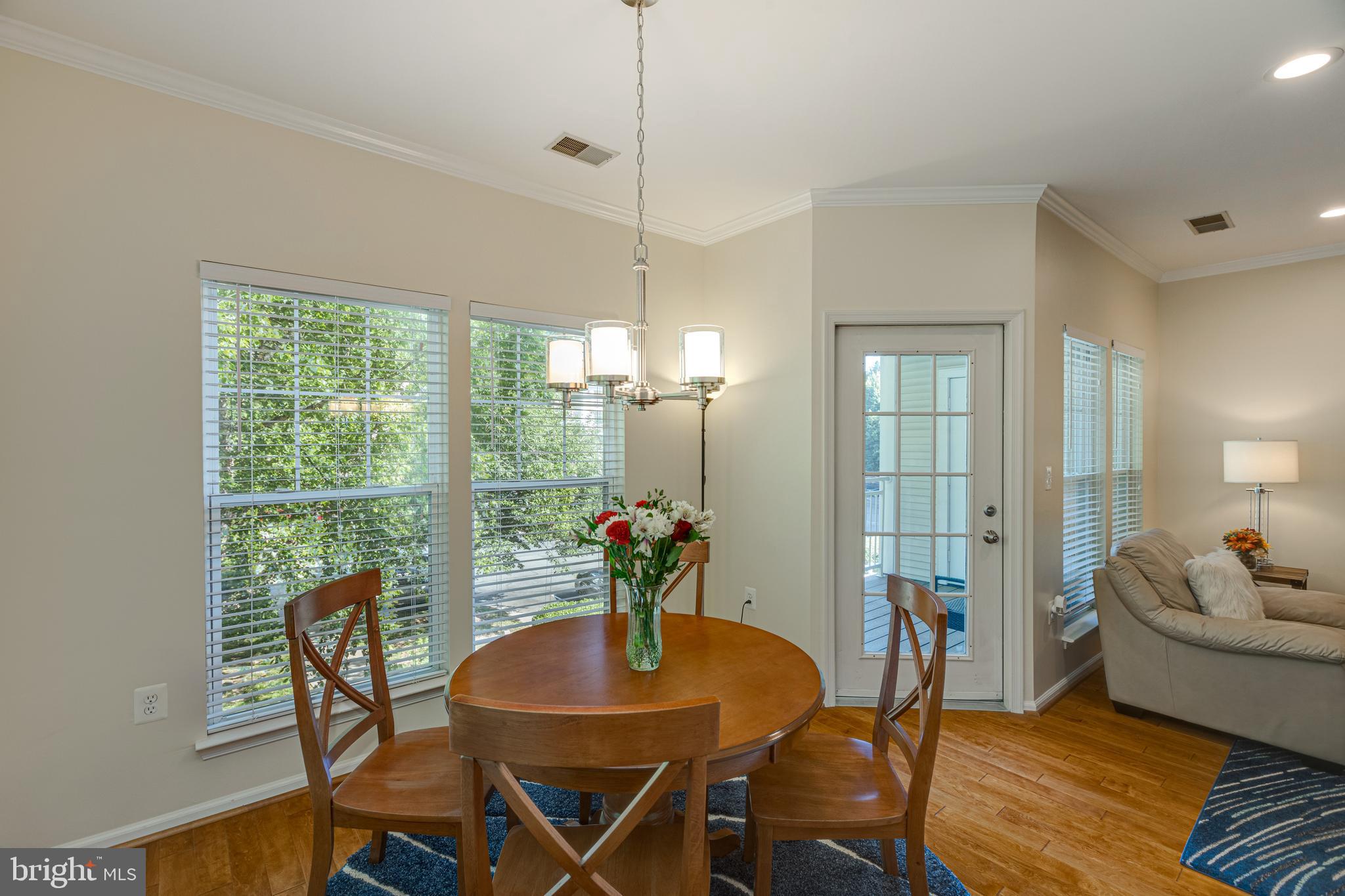 1511 North Point Drive, Unit 303 Reston, VA 20194 - Photo 8 of 29 Hardwood flooring in living room and dining room