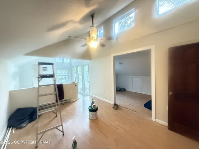 a bedroom with furniture and a mirror