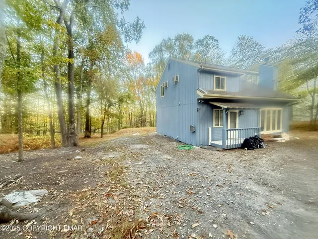 a view of a house with a tree